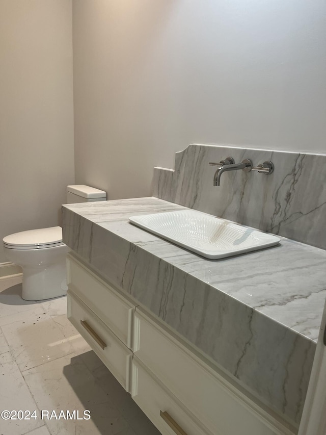 bathroom featuring vanity and toilet