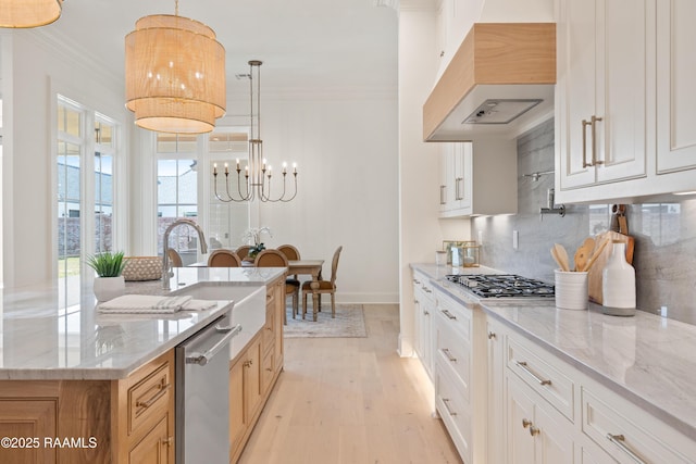 kitchen featuring custom exhaust hood, tasteful backsplash, appliances with stainless steel finishes, ornamental molding, and a sink