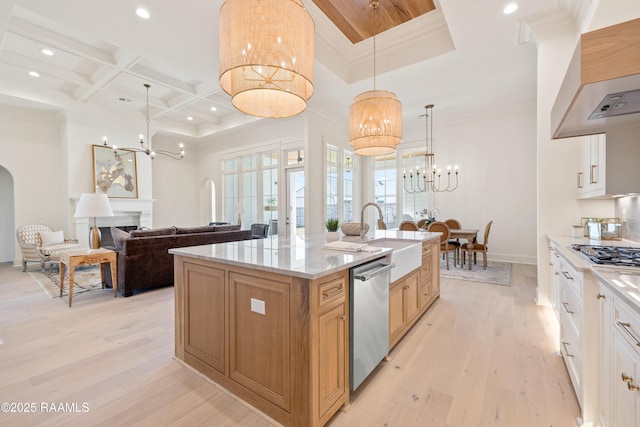 kitchen featuring appliances with stainless steel finishes, coffered ceiling, a notable chandelier, and a sink