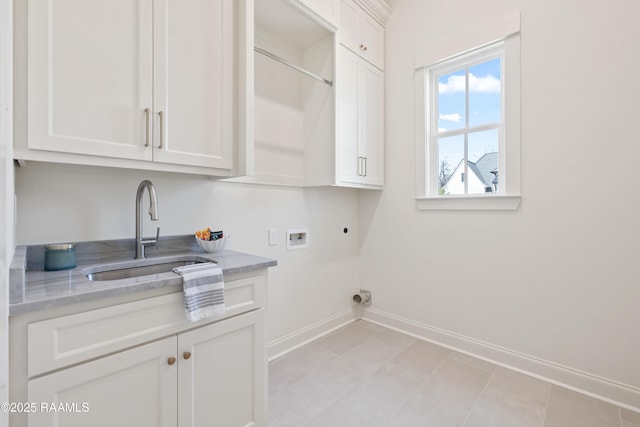 laundry room featuring cabinet space, baseboards, hookup for a washing machine, hookup for an electric dryer, and a sink