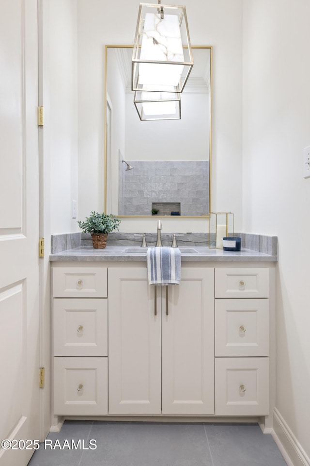 bathroom featuring tile patterned floors, baseboards, and vanity