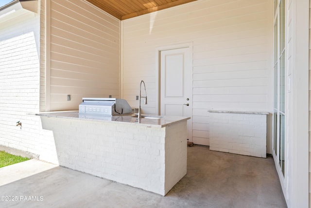 view of patio with a grill, an outdoor kitchen, and a sink