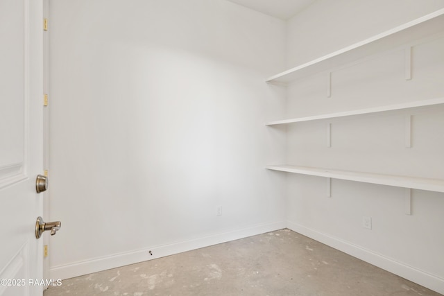 interior space with concrete floors and baseboards