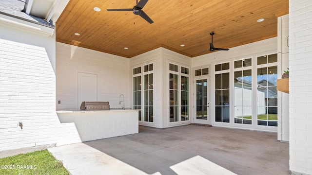 view of patio / terrace featuring a ceiling fan and exterior kitchen