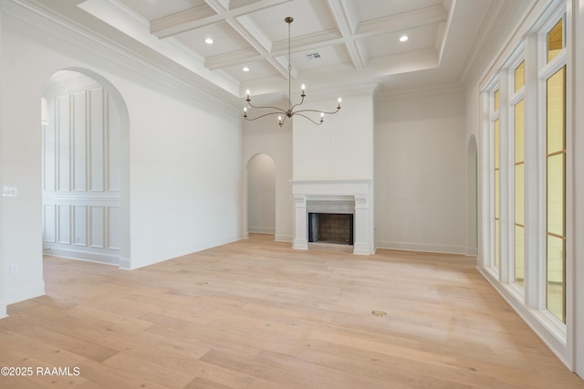 100 Winthorpe Row, Lafayette, LA 70503 - unfurnished living room featuring light wood-type flooring, arched walkways, beamed ceiling, coffered ceiling, and a notable chandelier