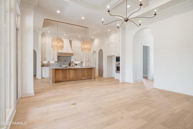 100 Winthorpe Row, Lafayette, LA 70503 - unfurnished living room featuring arched walkways, light wood-style flooring, and crown molding