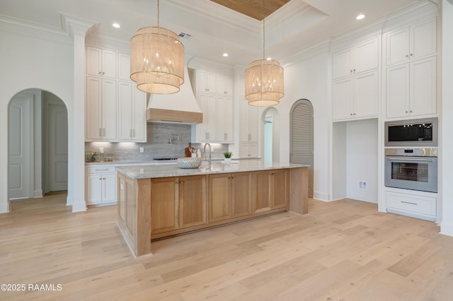 100 Winthorpe Row, Lafayette, LA 70503 - kitchen with arched walkways, light wood-type flooring, crown molding, decorative backsplash, and appliances with stainless steel finishes