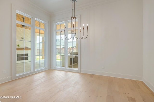 100 Winthorpe Row, Lafayette, LA 70503 - unfurnished dining area with light wood-type flooring, baseboards, a notable chandelier, and crown molding