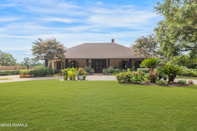 rear view of property with a lawn