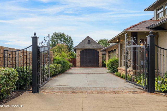 view of gate with a garage