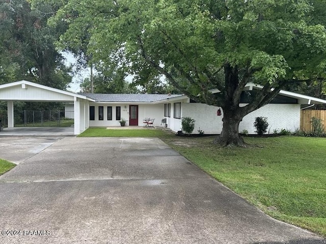 single story home featuring a front yard and a carport