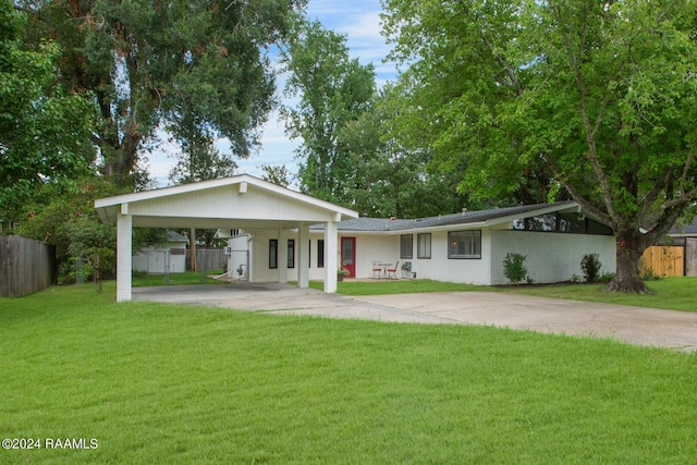 1013 Montrose Blvd, Lafayette, LA 70503 - ranch-style house featuring fence, driveway, an attached carport, and a front yard