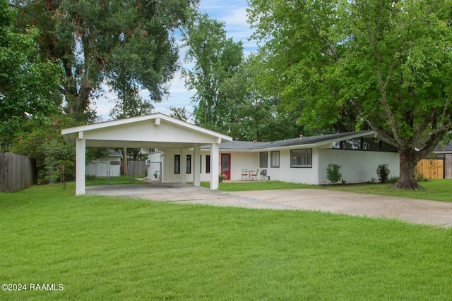 single story home featuring a carport and a front yard