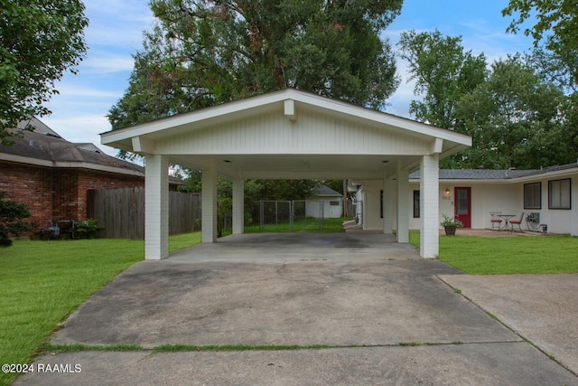 exterior space with a carport and a yard