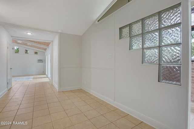 hall with light tile patterned flooring and lofted ceiling