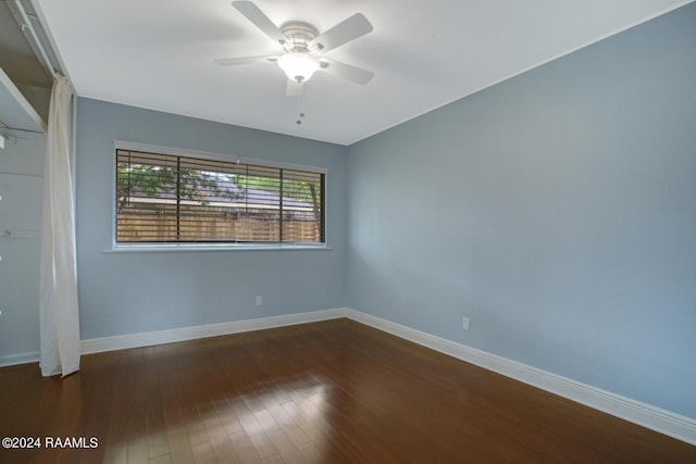 unfurnished room with dark hardwood / wood-style floors and ceiling fan