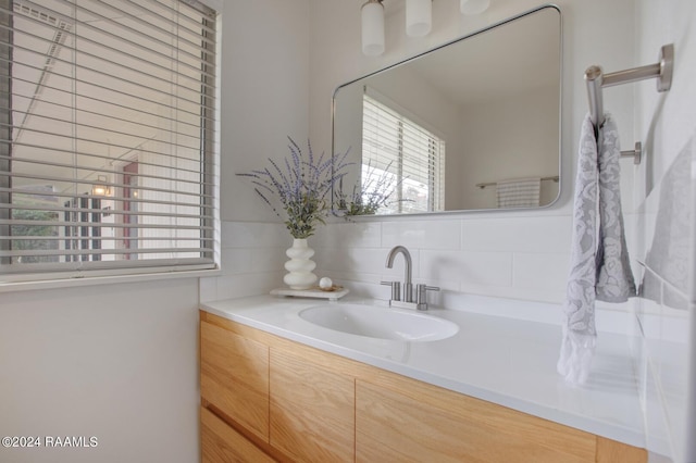 bathroom featuring tasteful backsplash and vanity