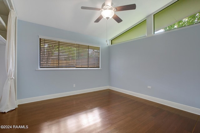 spare room with vaulted ceiling, dark hardwood / wood-style floors, and ceiling fan