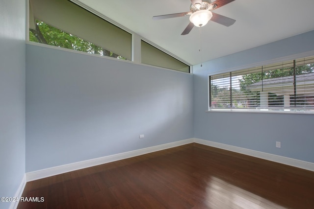 spare room with hardwood / wood-style floors, vaulted ceiling, and ceiling fan