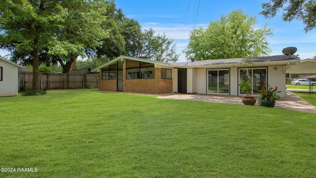 rear view of property with a yard