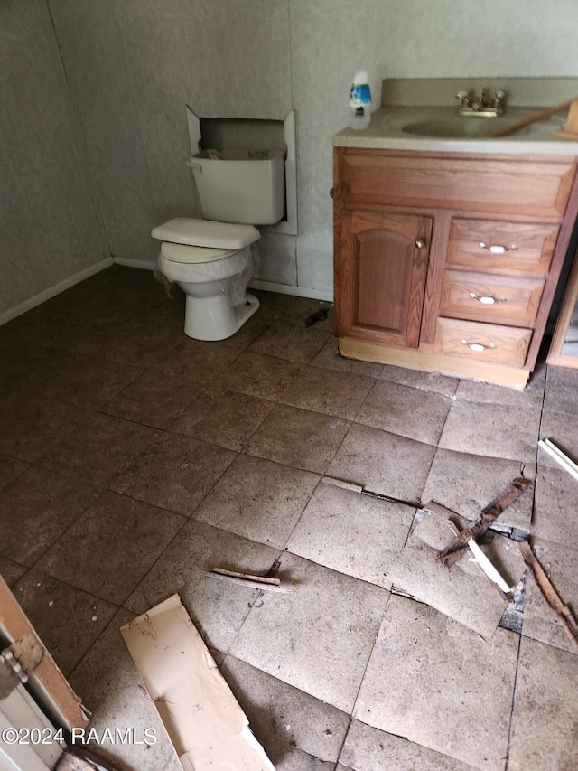 bathroom featuring tile patterned floors, vanity, and toilet