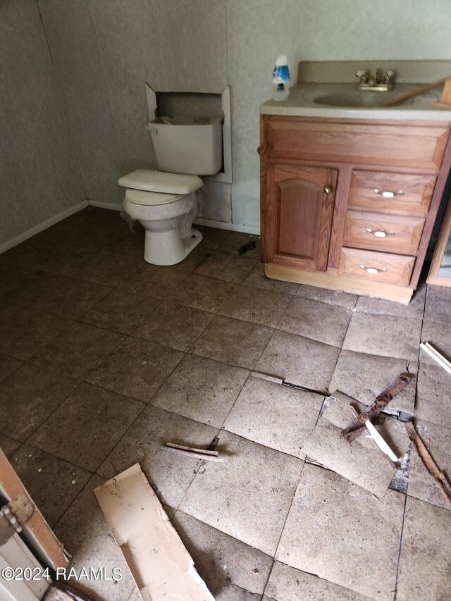 213 Robitaille Rd, New Iberia, LA 70560 - bathroom featuring toilet, vanity, and baseboards
