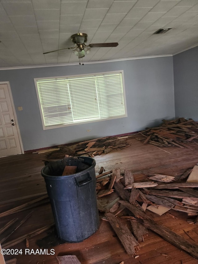 unfurnished bedroom featuring ceiling fan, wood-type flooring, and ornamental molding