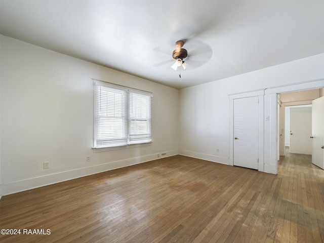 unfurnished bedroom featuring wood-type flooring and ceiling fan