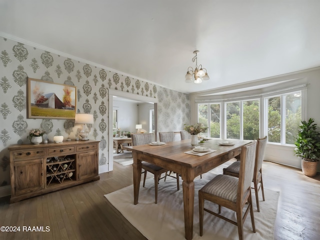 903 Myrtle Pl, Lafayette, LA 70506 - dining space with wallpapered walls, a chandelier, hardwood / wood-style flooring, ornamental molding, and baseboards