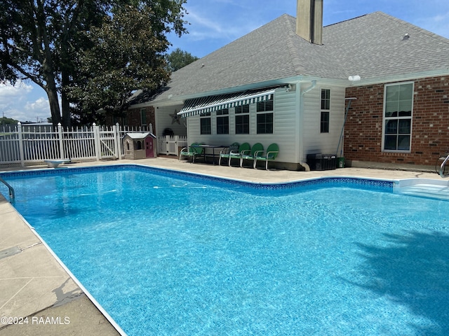 view of pool with a diving board