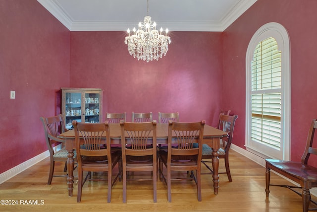 dining room featuring crown molding, a notable chandelier, and light wood-type flooring