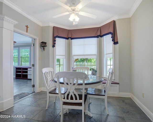 dining area with ceiling fan and crown molding