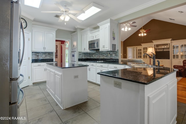 201 Marquette St, New Iberia, LA 70563 - kitchen featuring appliances with stainless steel finishes, a sink, a ceiling fan, a center island, and backsplash