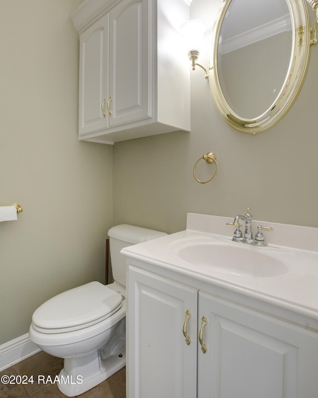 bathroom with tile patterned flooring, vanity, and toilet