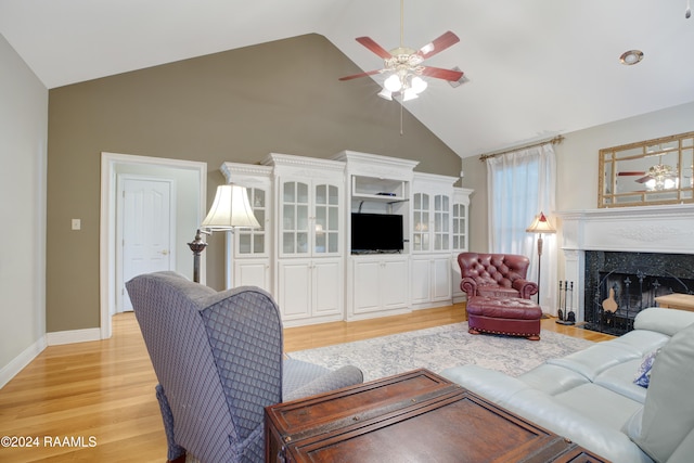 living room featuring a fireplace, light wood-type flooring, high vaulted ceiling, and ceiling fan