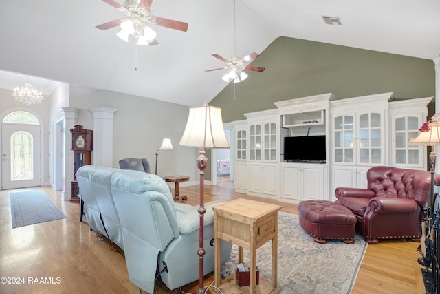 living room with high vaulted ceiling, ceiling fan with notable chandelier, and light wood-type flooring