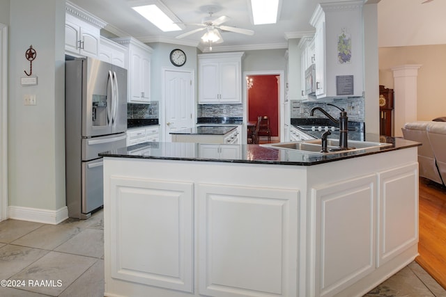 201 Marquette St, New Iberia, LA 70563 - kitchen featuring stainless steel appliances, a peninsula, a ceiling fan, backsplash, and white cabinetry