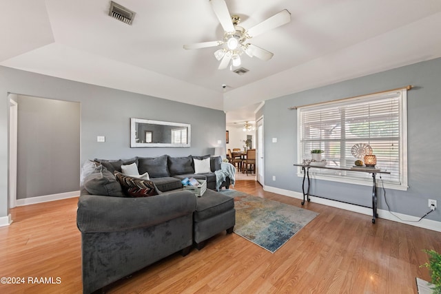 living room featuring light hardwood / wood-style flooring and ceiling fan