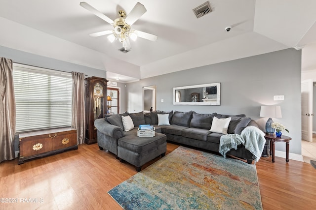 living room featuring wood-type flooring and ceiling fan