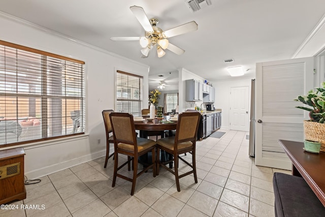 dining space with ornamental molding, light tile patterned floors, and ceiling fan