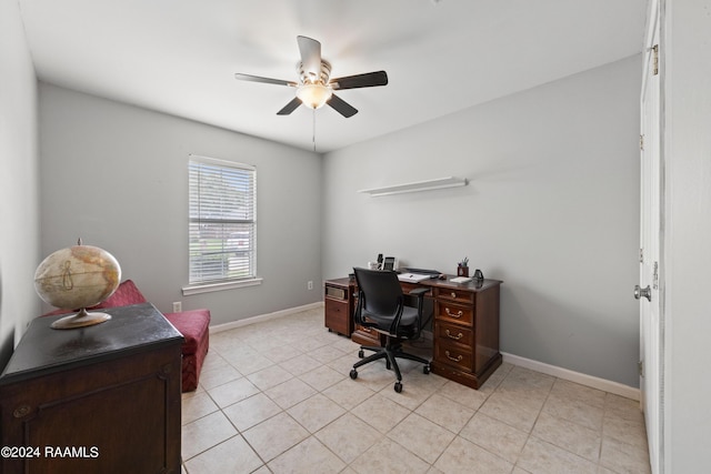 home office with light tile patterned floors and ceiling fan