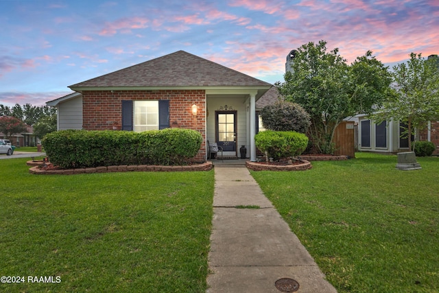 bungalow-style home featuring a yard