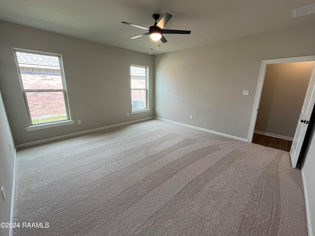 spare room with light carpet and ceiling fan