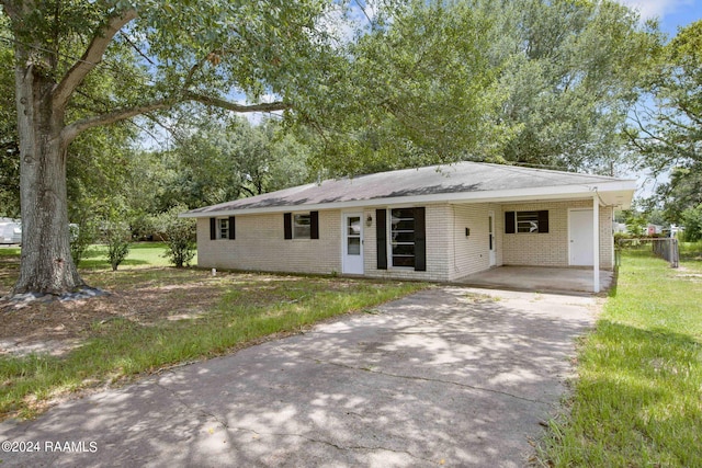 single story home with a front yard and a carport