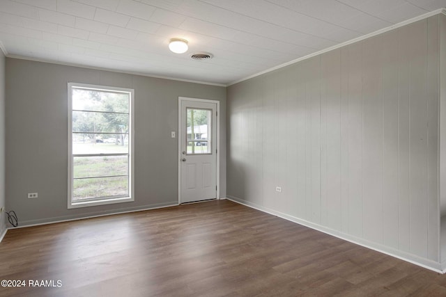 foyer with dark hardwood / wood-style floors and crown molding