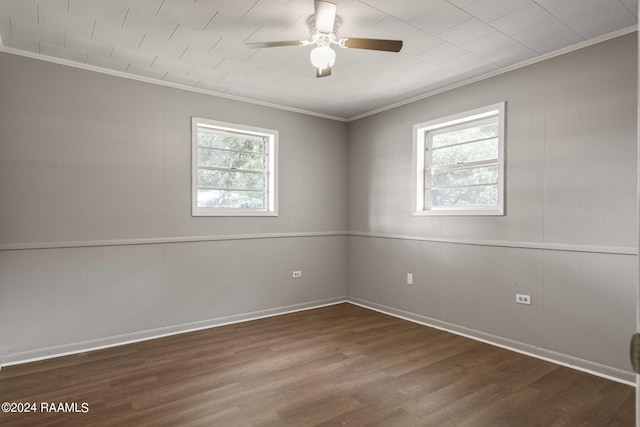 spare room featuring dark hardwood / wood-style flooring, ceiling fan, and ornamental molding