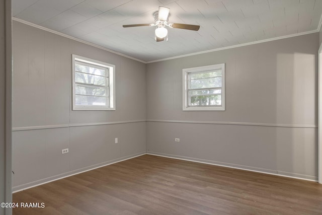 unfurnished room with hardwood / wood-style floors, ornamental molding, and a wealth of natural light