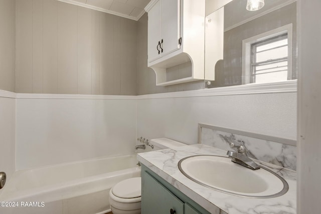 bathroom with a bathing tub, vanity, toilet, and ornamental molding