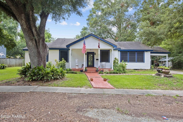 view of front of home featuring covered porch and a front yard