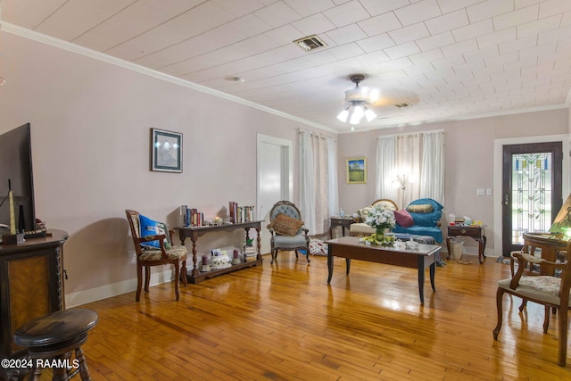 interior space with ceiling fan, ornamental molding, and wood-type flooring